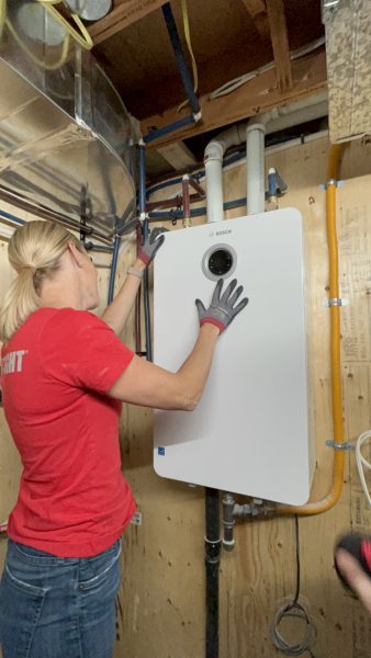 Sherry Holmes with Bosch Greentherm-9900i-SE Tankless Water Heater installed on job site.