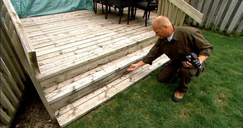 inspecting rotting deck