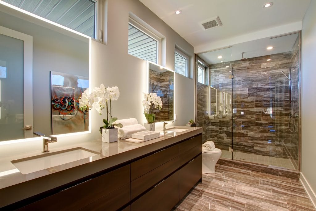 Don’t use hardwood in your bathroom, instead use tile that mimics a wood feel. Bathroom by Rinaldi Homes.