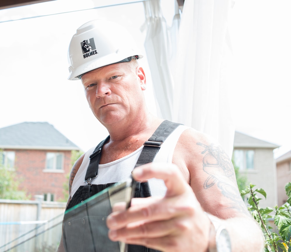 Mike Holmes Holding A Window