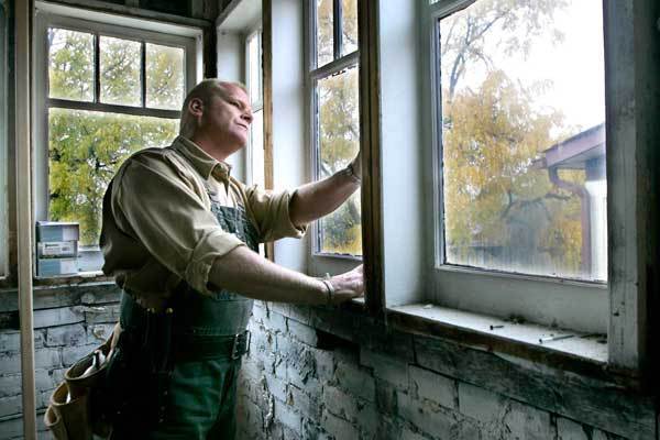 Mike Holmes Examining Windows For Air Leaks
