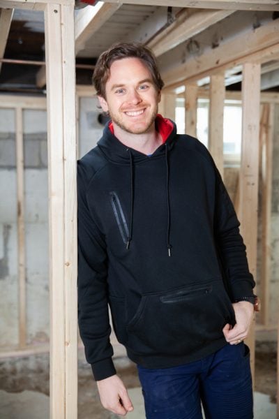 Michael Holmes offers a bright smile during the Young family basement renovation in HGTV's Holmes Family Rescue