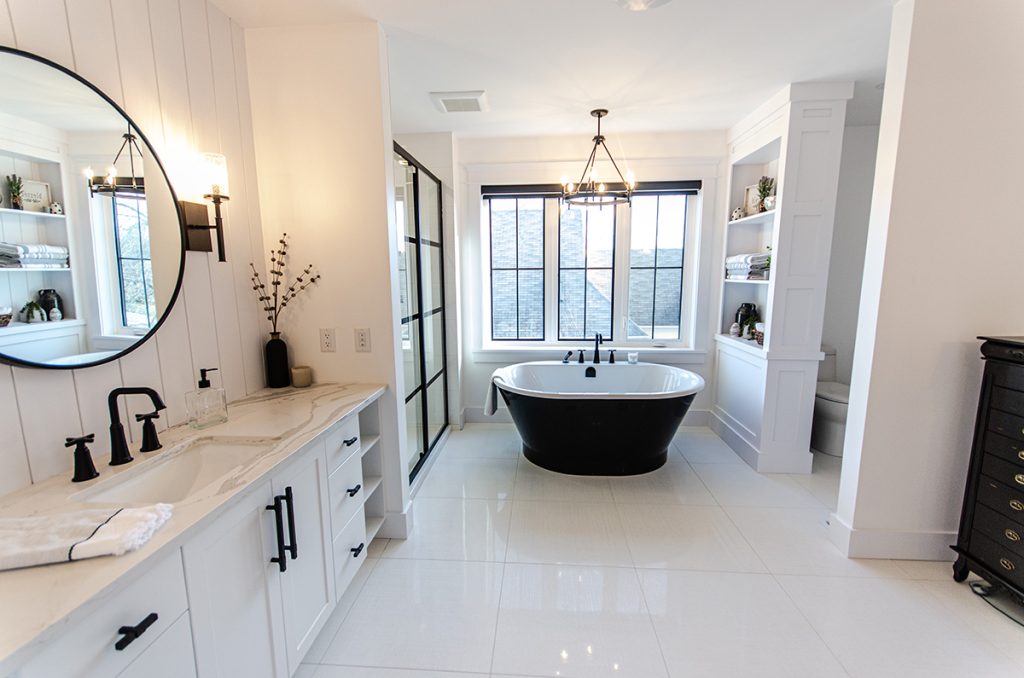 This freestanding tub looks great in this black and white themed bathroom by Chris Franklin Homes, Holmes Approved Homes Builder.