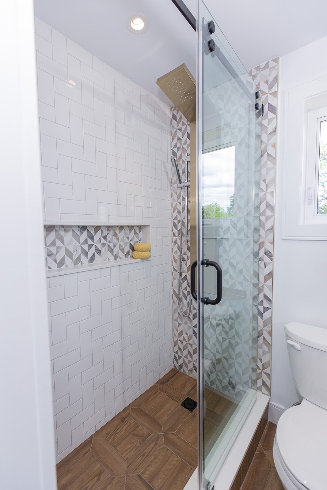 Frameless shower installed in small bathroom project on Holmes Family Rescue