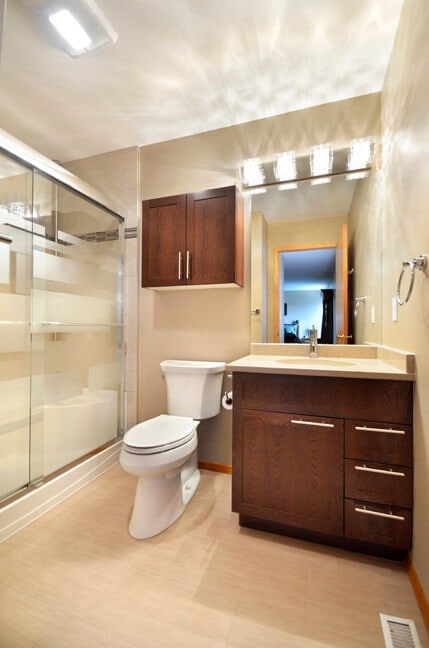 A medicine Cabinet was installed above the toilet to save space. Bathroom completed by All Canadian Renovations, Holmes Approved Homes Builder