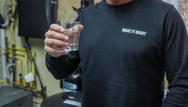 Mike Holmes Holding Glass Of Water From His Reverse Osmosis Drinking Water System