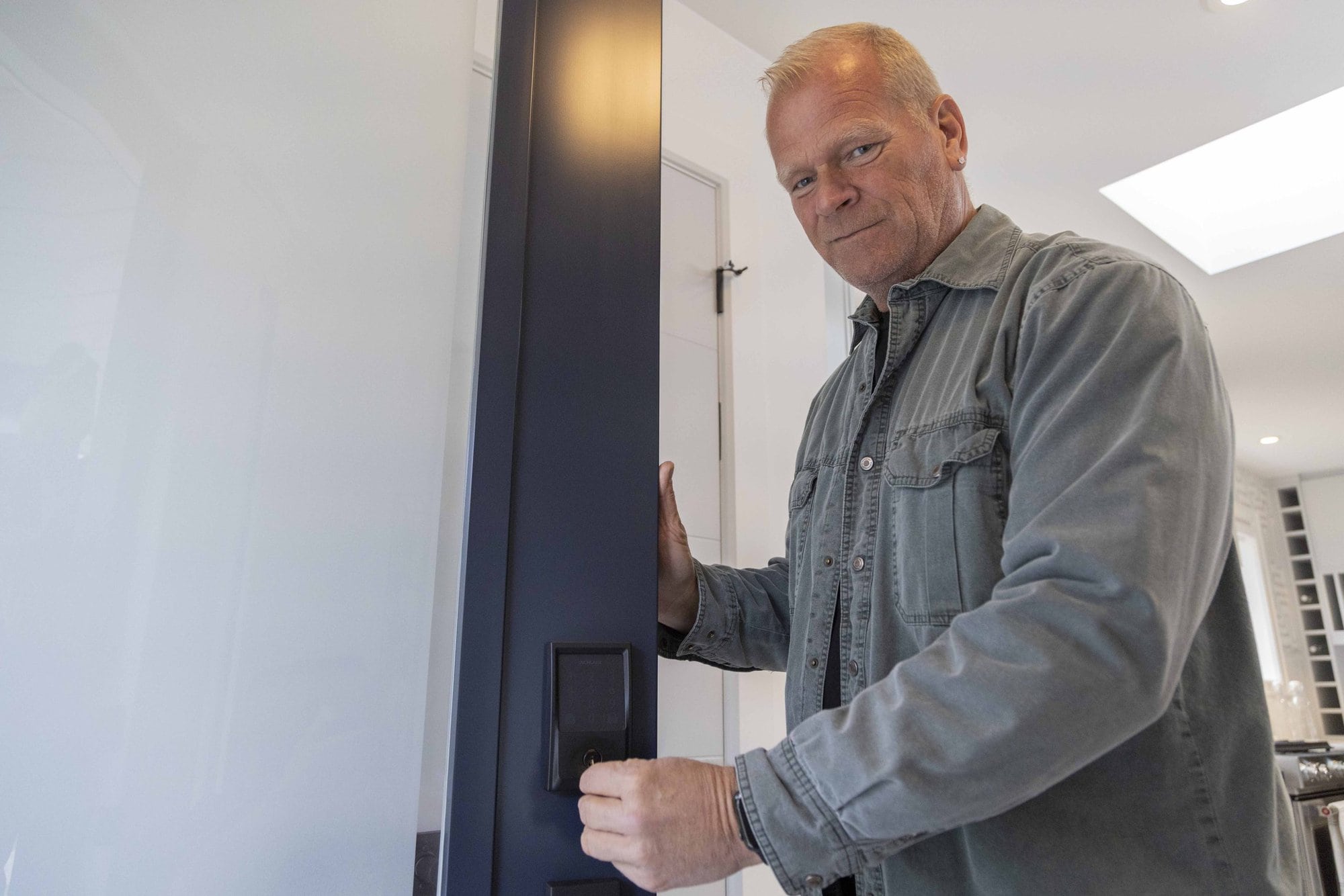 Mike Holmes installing Schlage Encode Lock On Door