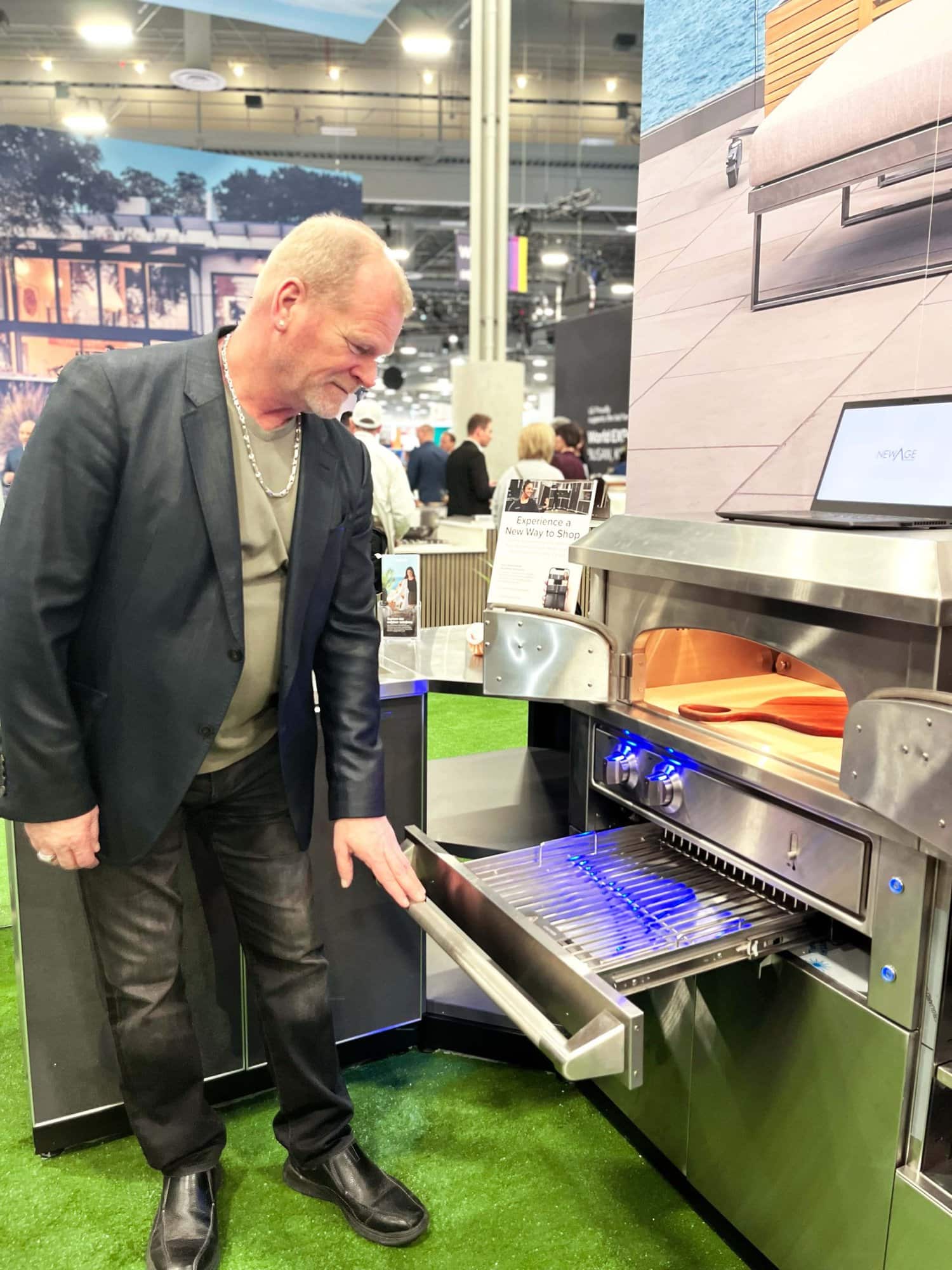 Mike Holmes Checking Out The NewAge Pizza Oven At IBS