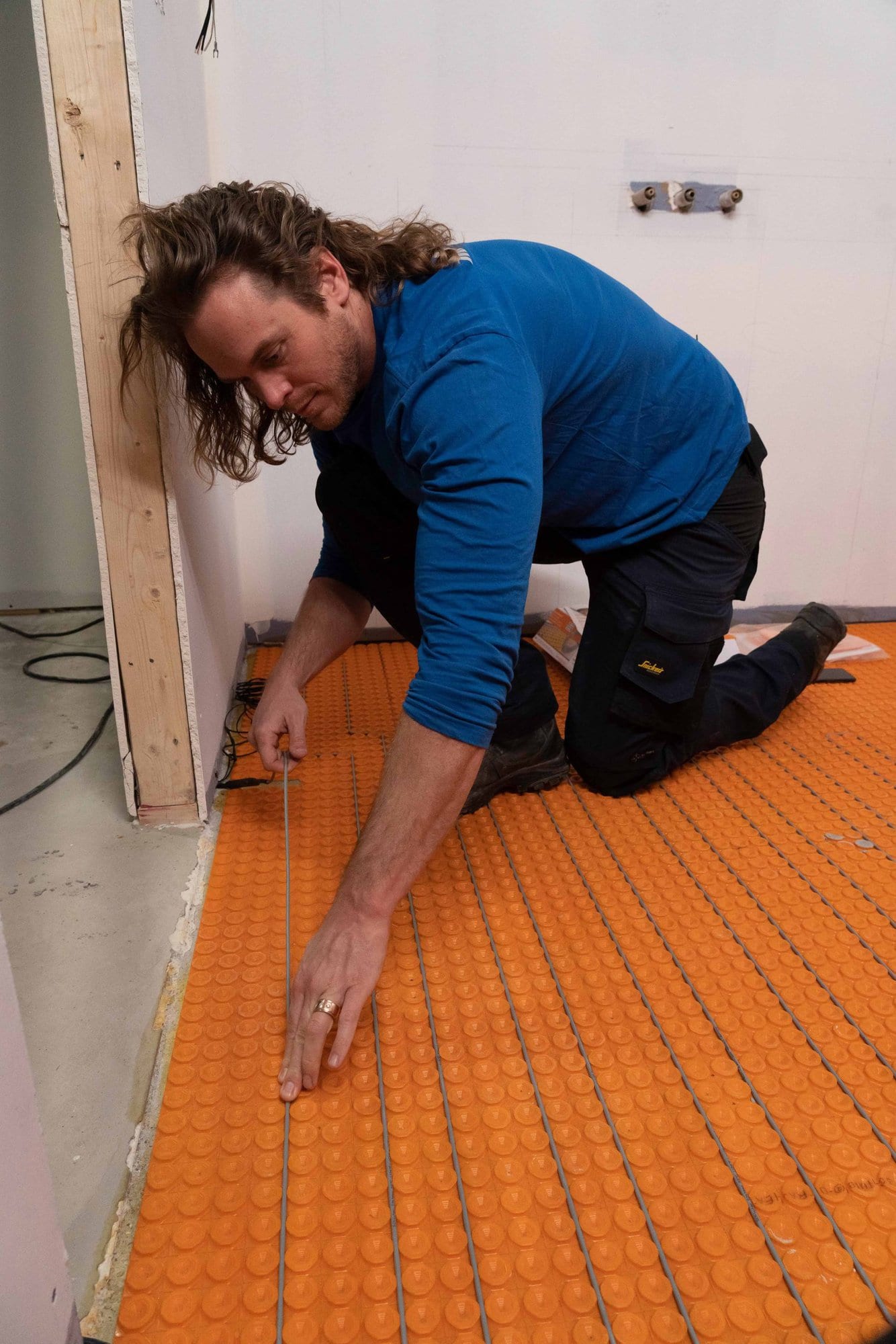 Mike Holmes Jr installing Schluter Ditra-Heat-Duo in-floor warming system on Holmes Family Rescue.