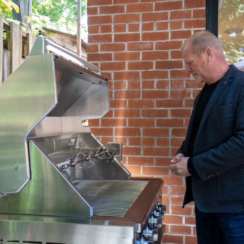 Mike Holmes checking out BBQ on Holmes Family Rescue Season 2