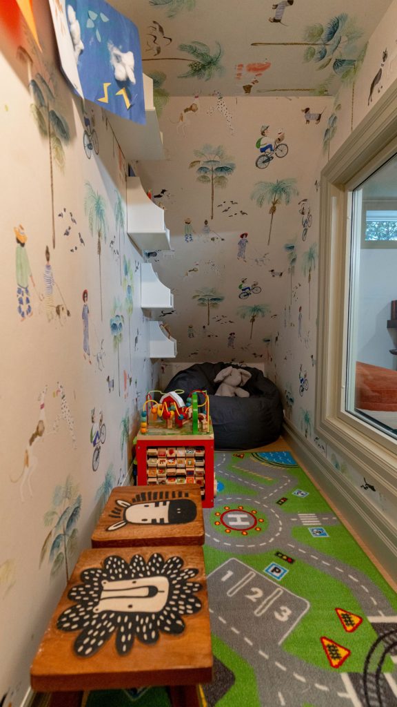 Wallpaper Ideas From Mike Holmes Projects. Kids play nook under the stairs with fun kids wallpaper with simple kids illustrations.