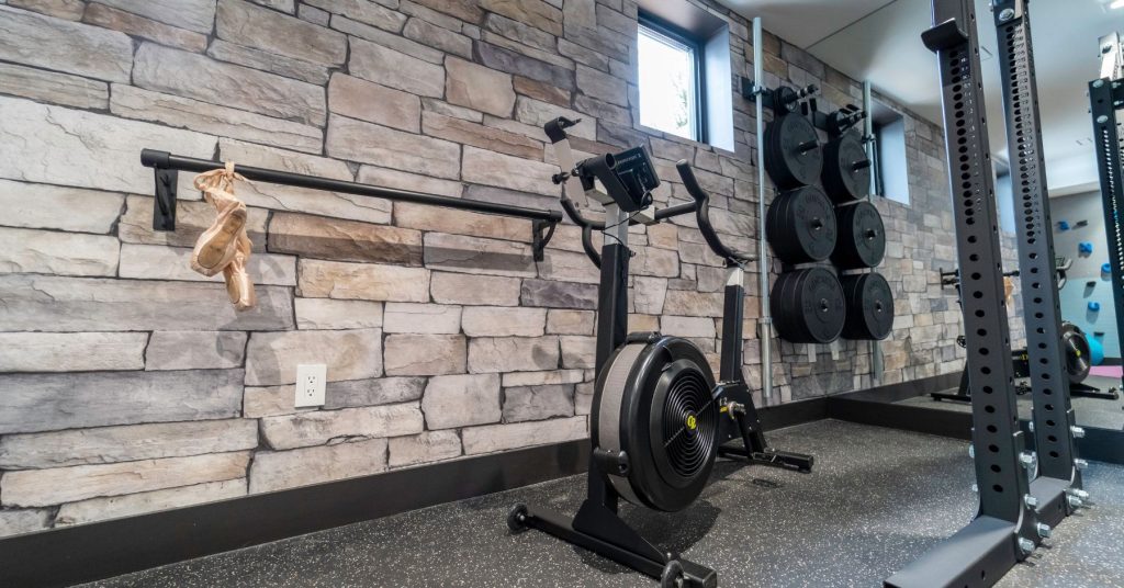 Wallpaper Ideas From Mike Holmes Projects. Real stone look wallpaper in this home gym.