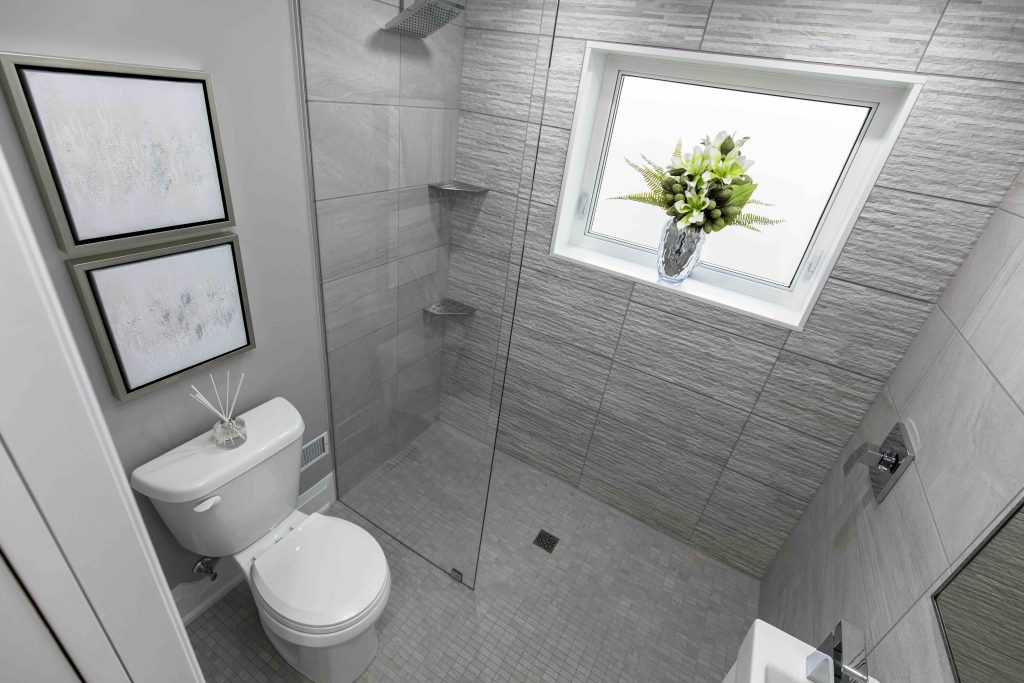 Fully accessible bathroom with curbless shower for Jake and pocket door for easy maneuverability