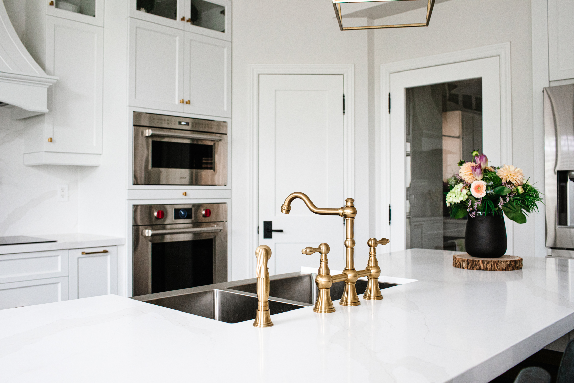 Image of a walk-in kitchen pantry with neatly organized shelves holding food items and supplies. The space is clean, functional, and designed for efficient storage.