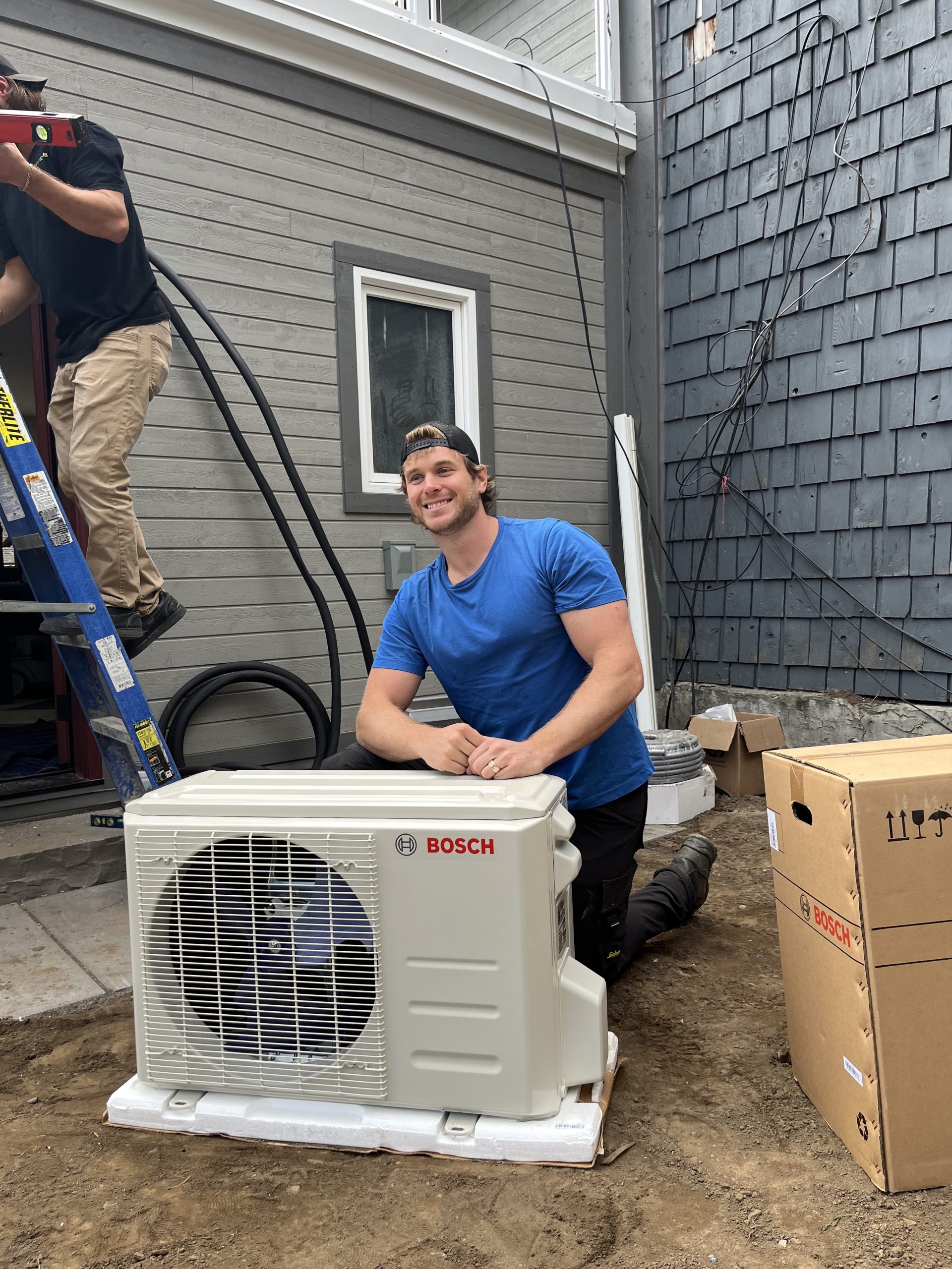 A Bosch mini-split heat pump unit mounted on the wall inside a renovated mudroom addition, part of a ductless HVAC solution for efficient year-round climate control.