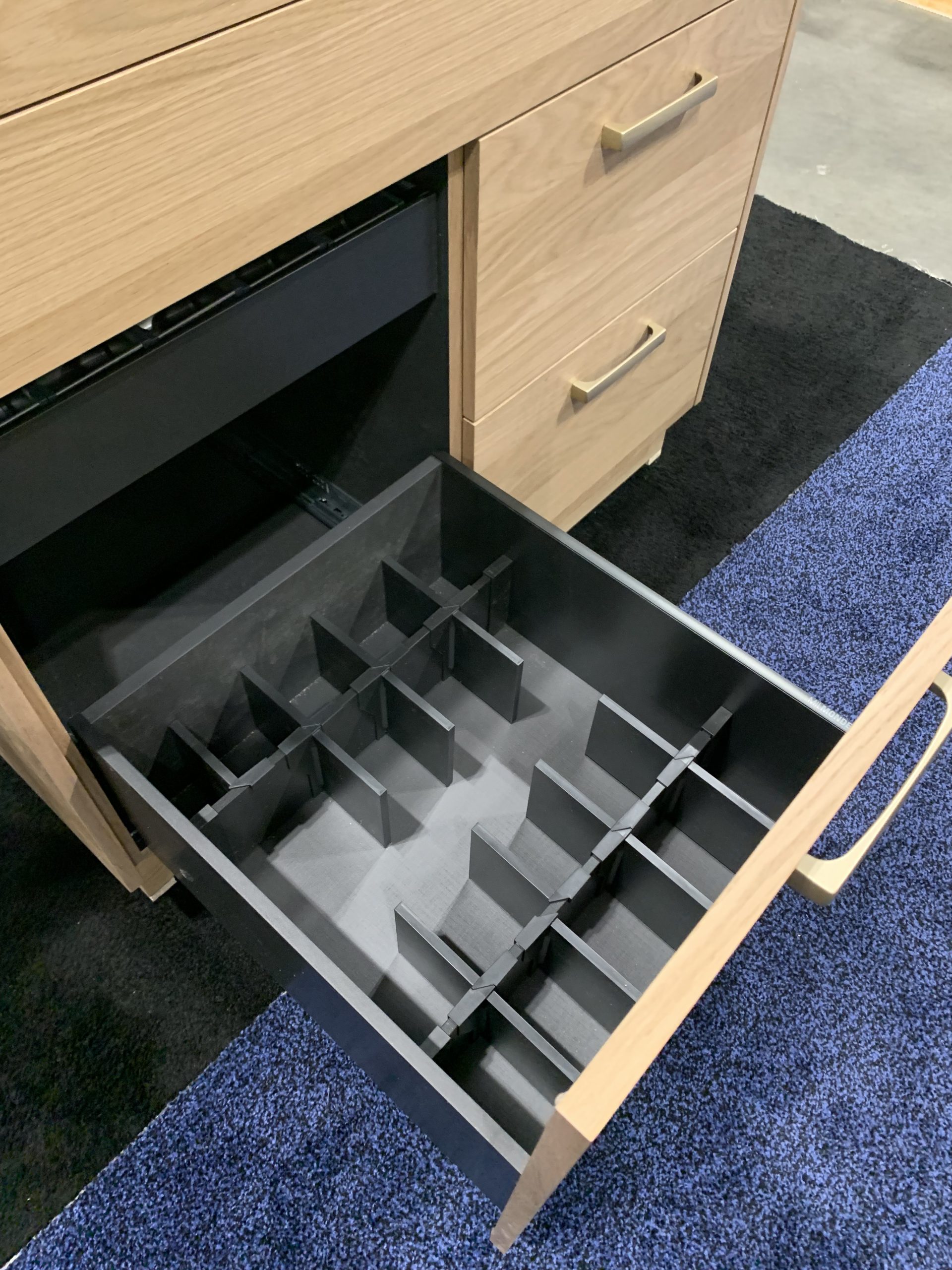 Image showcasing tall pantry pull-out shelves, overhead spice racks, and custom wall storage solutions. Features include adjustable shelving and removable drawer dividers, providing flexible storage for items like bottles and large pots, all designed for long-term adaptability.